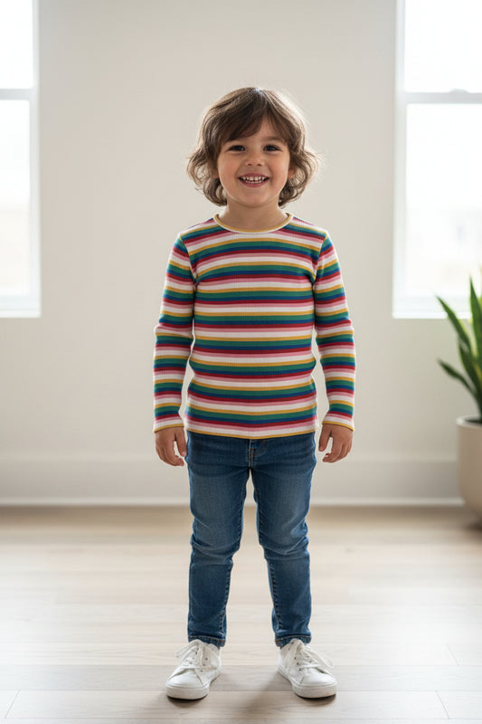 A long-sleeve ribbed knit top with vertical multicolor stripes in pink, green, blue, yellow, and white, laid flat on a textured white fabric background.