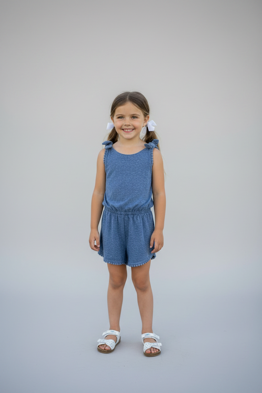 A pair of blue denim shorts for girls, displayed on a white hanger, with a tag indicating the size as 0000.