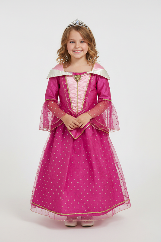 A young girl wearing a pink princess costume with a tiara, standing against a light gray studio background.